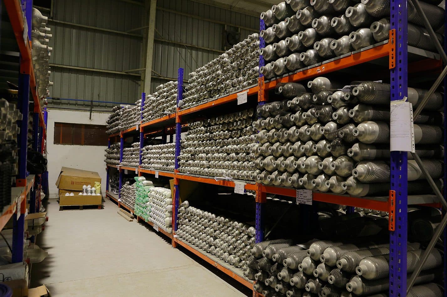 Racks of high-pressure Uttam cylinders in a warehouse