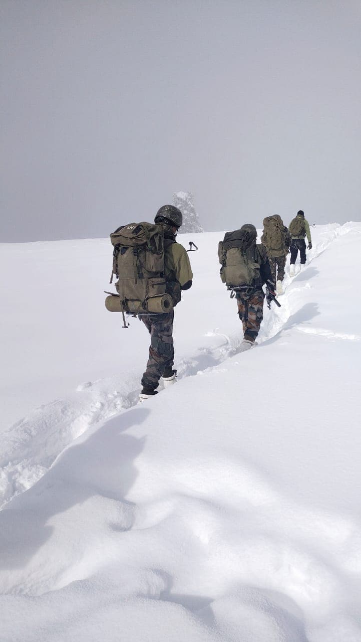 Indian Army soldiers on a high-altitude patrol through deep snow